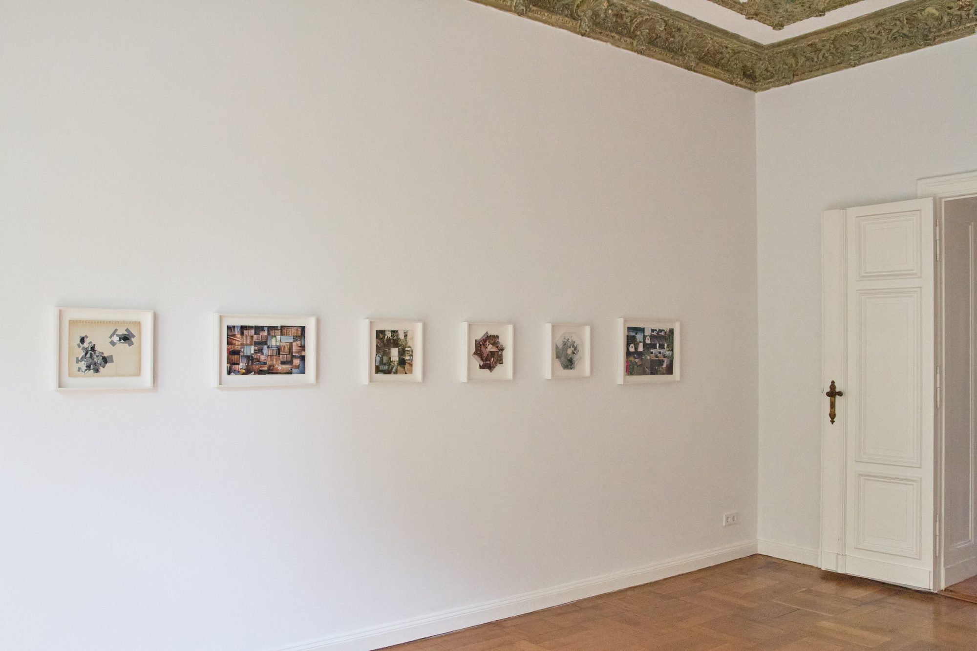 Framed photographic montages by Maria Wallace on a white wall, installation view